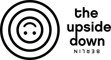 Simple black and white umbrella icon with raindrops above.